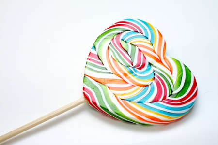 Close up of colourful lollipop, heart shape.の写真素材