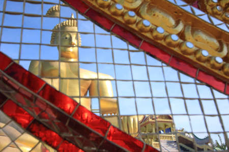 Reflection of big golden buddha with blue sky, Ang Thong province, Thailand.の写真素材