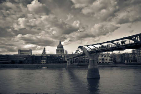 London photography containing Millennium Bridge, St. Paulâs cathedral and other buildings with pronounced cloudsのeditorial素材