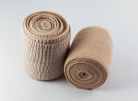 Two Elastic ACE compression bandage warp unwrapped isolatedの写真素材