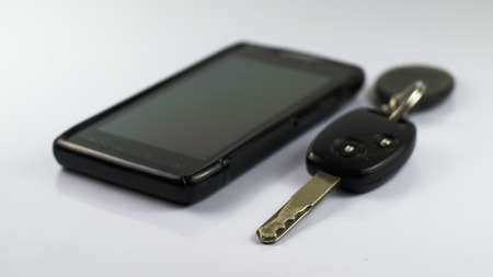 Car key and smartphones isolated on white backgroundの写真素材