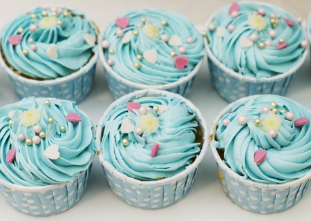 Cup cake with blue cream close up sweet food backgroundの写真素材