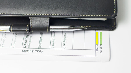 business concept with note book and pen close up of Plan and actualの写真素材