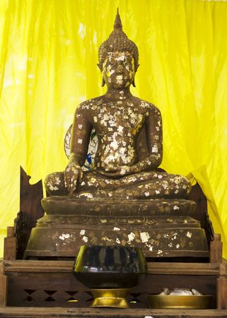 Buddha statue close up in temple on yellow の写真素材