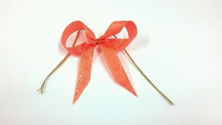 Orange ribbon bow isolated on white backgroundの素材