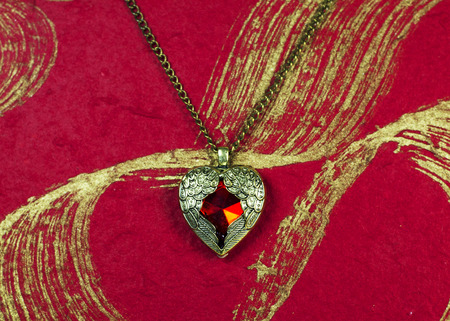 Pendant necklace vintage Red heart shape on abstract backgroundの写真素材