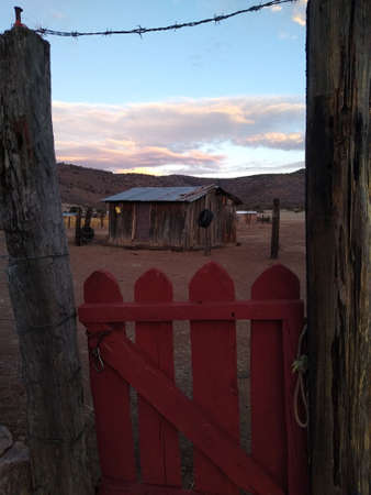 Old wooden fence in the middle of the desert in the evening lightの写真素材
