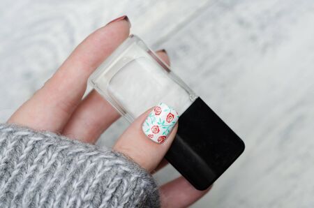 pink blue and gold manicure with floral printの写真素材