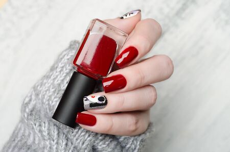 red manicure in the style of pop art pattern with a black white woman with red lips on checkered backgroundの写真素材