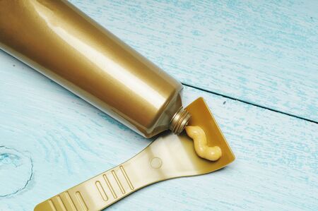 Depilation cream squeezed out of the tube onto the spatulaの写真素材