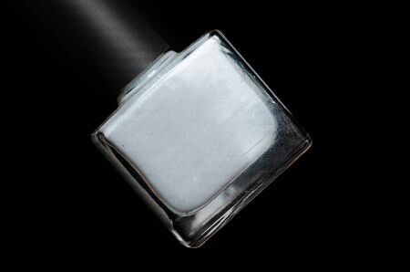 grey shimmer nail polish bottle on a black backgroundの写真素材