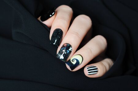 Black nail art Halloween manicure in the style of nightmare before Christmas with skull and cobwebsの写真素材