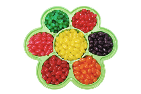 A colorful selection of jelly beans in a flower shaped dish - for spring or summer celebrations の写真素材