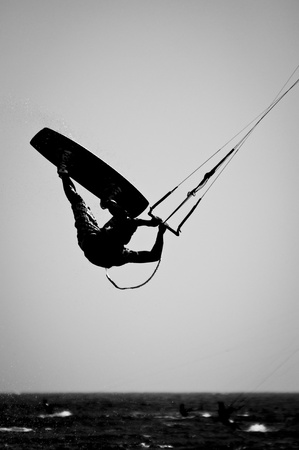 A Silhouette of a kite surfer in a Black   White finish の写真素材