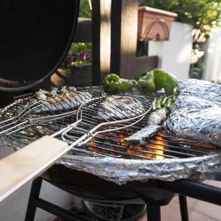 A healhty mediterranean BBQ consisting of fresh fish and vegetablesの写真素材