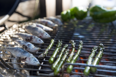 A healhty mediterranean BBQ consisting of fresh fish and vegetables
