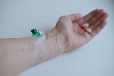 Health and medicine concept.Pills and pharmaceuticals. Colored capsules in hand on a white...