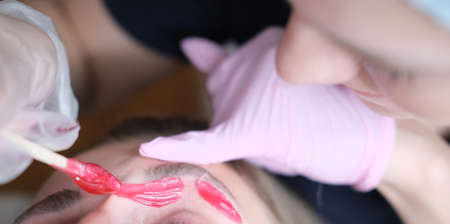 Hair removal, modeling of eyebrows with waxの写真素材