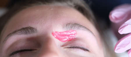 Hair removal, modeling of eyebrows with waxの写真素材