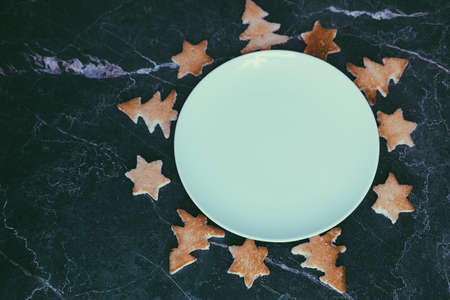 Bread toast in the shape of a Christmas tree and stars lie on a white plate, close-up. Selective focusの写真素材
