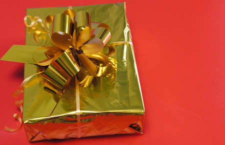 Gift close-up on a red background. Purchase online. Concept for Christmas, New Year 2022, Black...