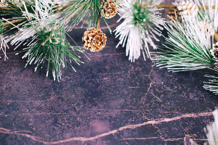 New Year and Christmas gifts. Selective focus. Santa claus hat, boxes with gifts, beads, Christmas toys on a dark backgroundの写真素材