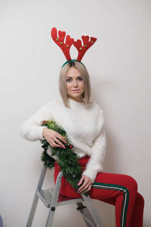 Portrait of a beautiful girl on a light background. The concept of Christmas and New Yearの写真素材