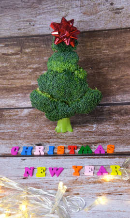 Christmas tree made from broccoli, on a wooden background, close-up, selective focus. 2022,2023.の写真素材