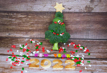 Christmas tree made from broccoli, on a wooden background, close-up, selective focus. 2022,2023.の写真素材