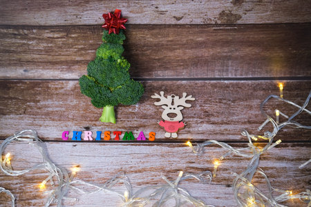 Christmas tree made from broccoli, on a wooden background, close-up, selective focus. 2022,2023.の写真素材