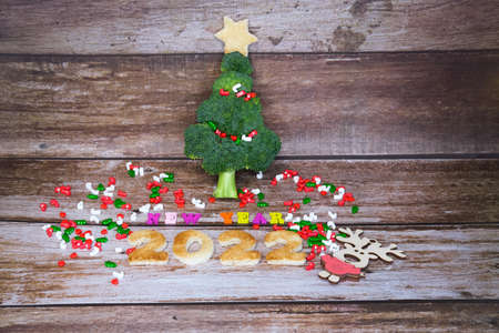 Christmas tree made from broccoli, on a wooden background, close-up, selective focus. 2022,2023.の写真素材