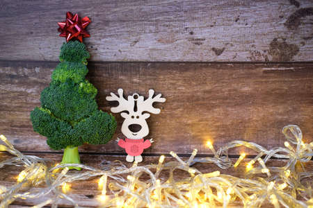 Christmas tree made from broccoli, on a wooden background, close-up, selective focus. 2022,2023.の写真素材