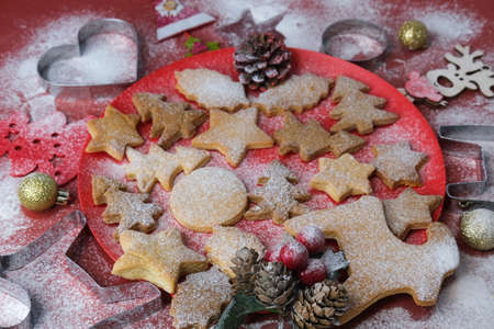 Christmas still life close up. Gingerbread cookies on a red background. Selective focus.の写真素材