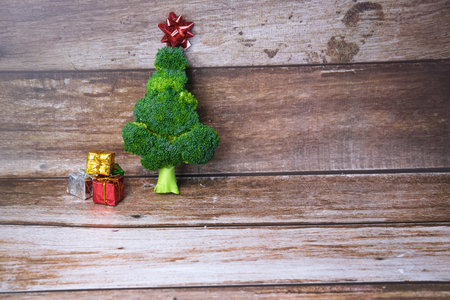 Christmas tree made from broccoli, on a wooden background, close-up, selective focus. 2022,2023.の写真素材