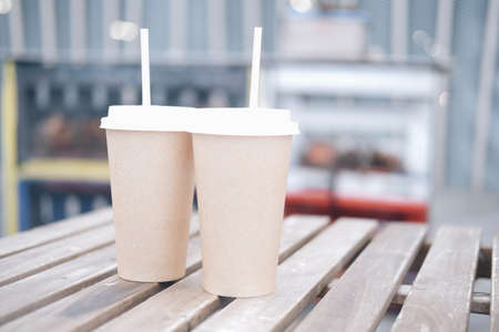 Paper cups stand on a wooden table. Takeaway coffee.の写真素材