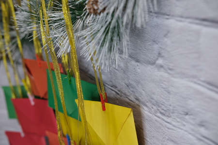 Advent calendar on a background of a brick wall. Multicolored envelopes made by hand.の写真素材