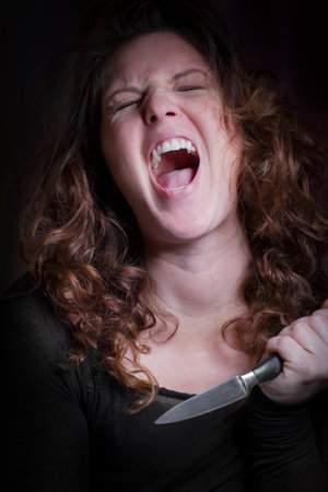Screaming woman with knifeの写真素材