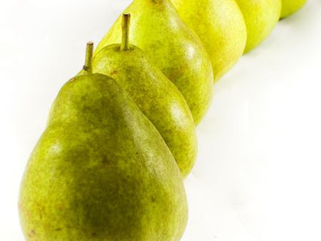 Row of green organically grown pears isolated on white.の写真素材