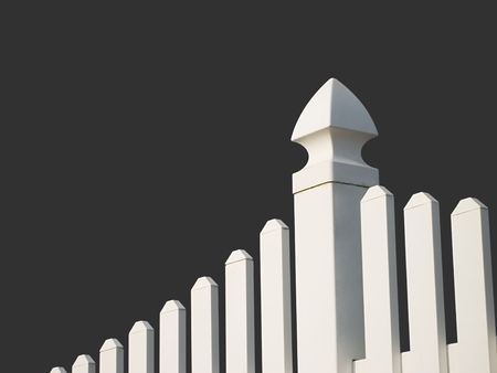 White picket fence with dark background.の写真素材