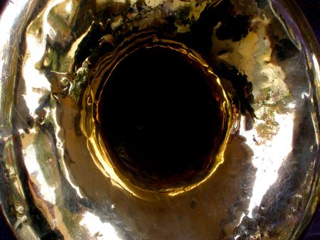 Damaged and battered sousaphone bell that can be used for an abstract or a background.