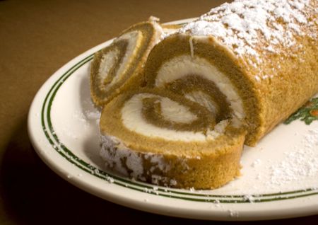 Pumpkin roll with cream cheese filling and powdered sugar on top.の写真素材