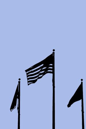Sillouette of an American flag and two others on flag poles on a blue background.の写真素材