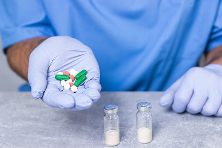 Medical tablets. Pills medicine. Bottle of pills in doctor hands