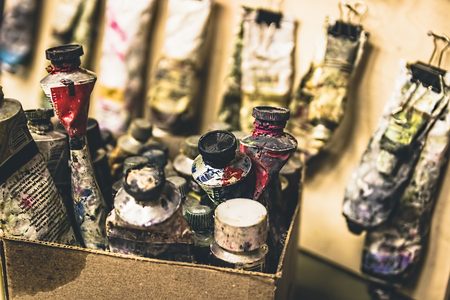 Artistic equipment. Oil paints. Paint brushes. Retro toned photo.の写真素材