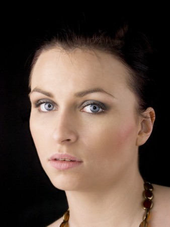 Portrait of young beautiful woman on black background. の写真素材