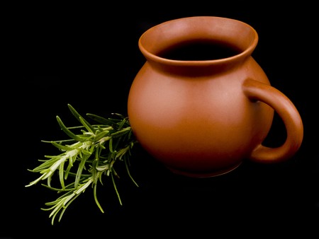 Ceramic cup and fresh rosemary on black backgroundの写真素材