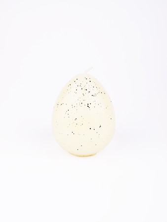 White candle formed in egg on white backgroundの写真素材