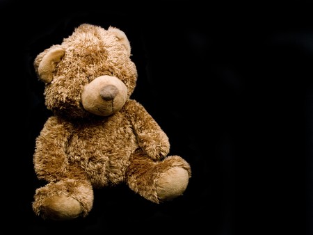 Brown teddy-bear on black backgroundの写真素材