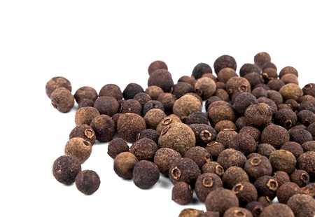 Closeup picture of whole allspice berries on white background