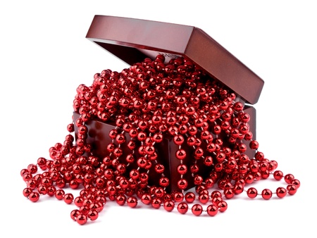 Christmas garland made from small red beads in wooden box, on white background.の写真素材